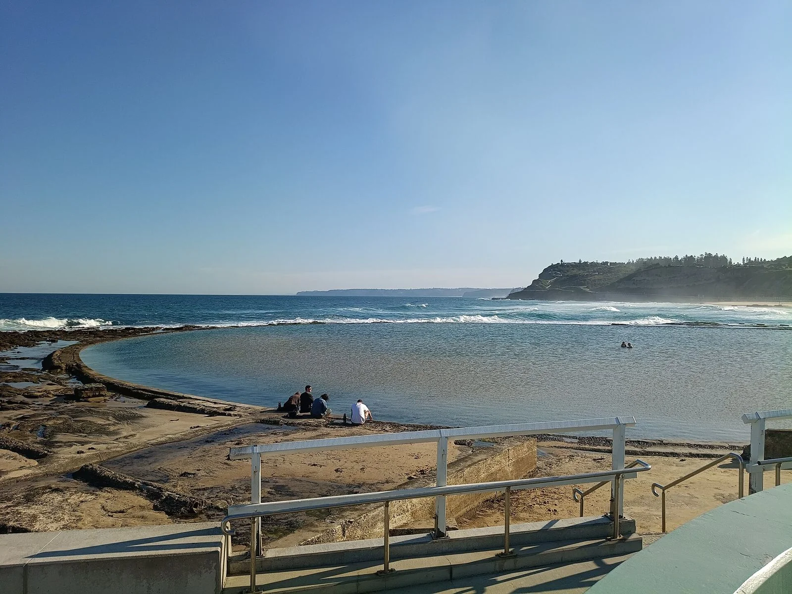 The shallow Canoe Pool at Newcastle Ocean Baths on a calm morning