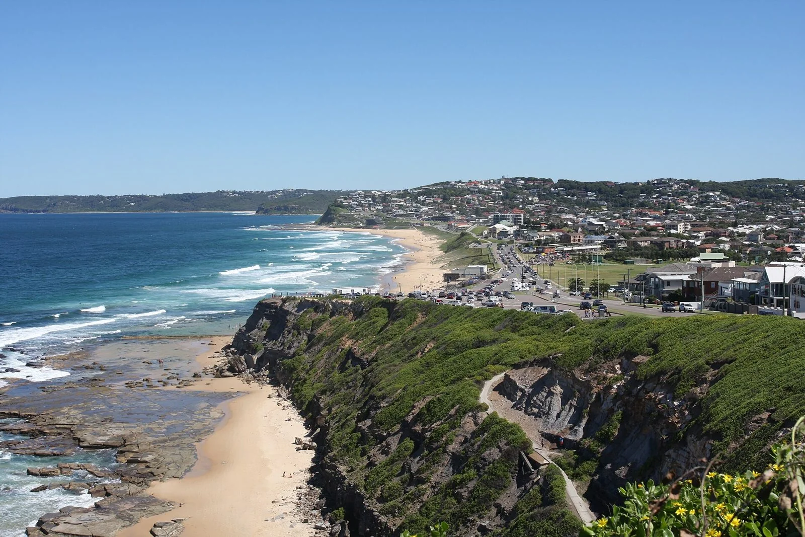 The Newcastle coast from the clifftop above Bar Beach, the surf breaking along the sand