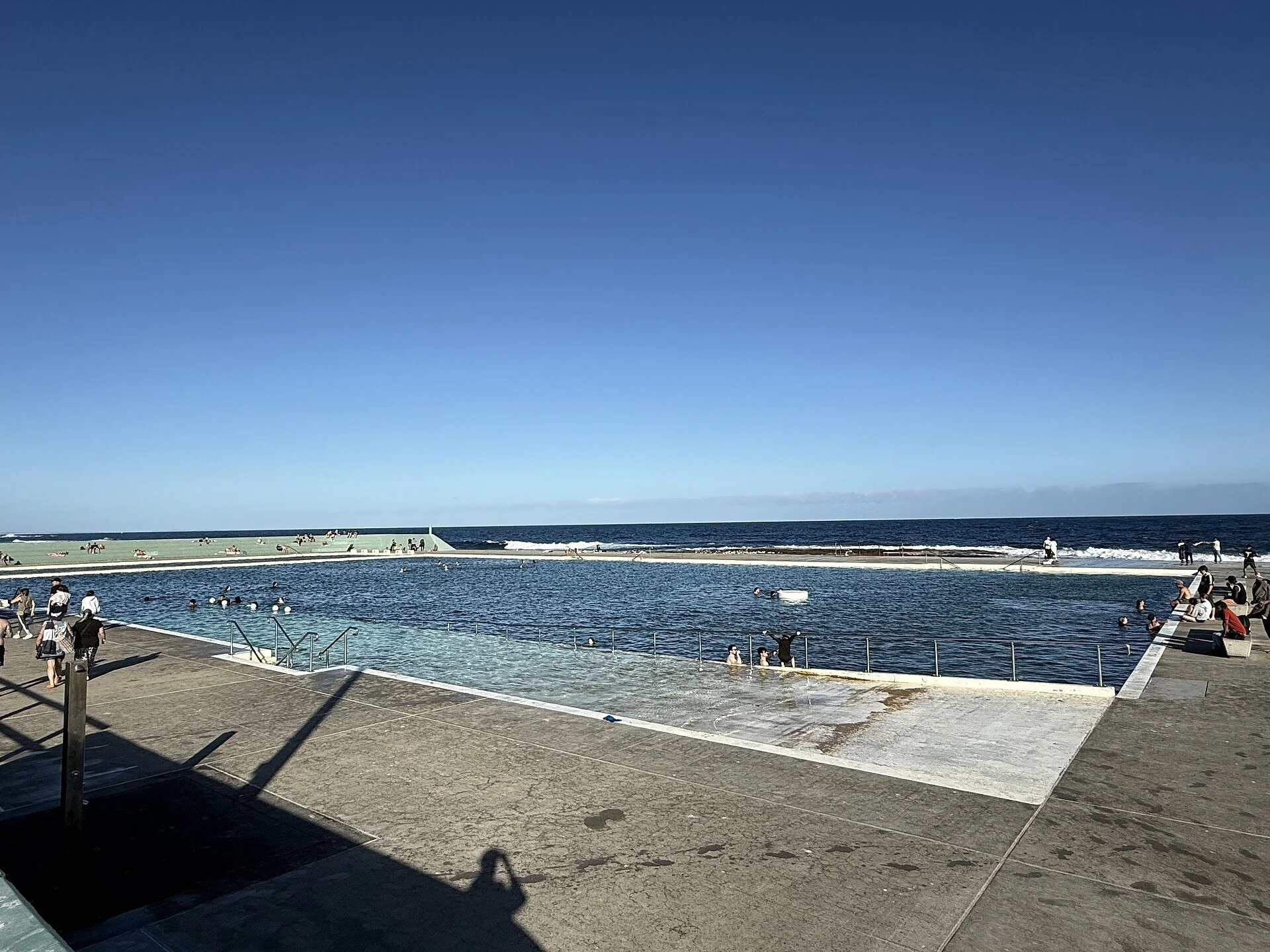 The lap pool at Newcastle Ocean Baths, with the ocean beyond the wall